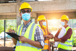 team-construction-engineers-three-architects-are-ready-wear-medical-masks_61243-701
