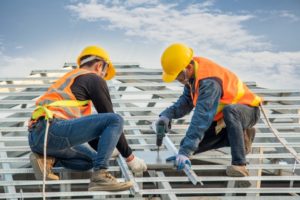 construction-worker-wearing-safety-harness-belt-during-working-installing-concrete-roof-tile-top-new-roof_64073-449